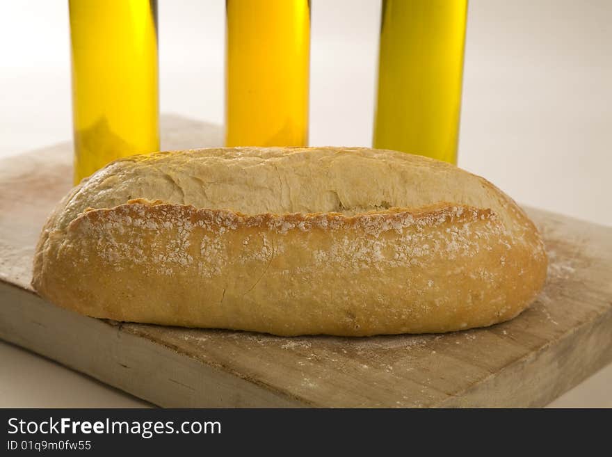 Italian artisan bread on cutting board with eggs and wine. Italian artisan bread on cutting board with eggs and wine.