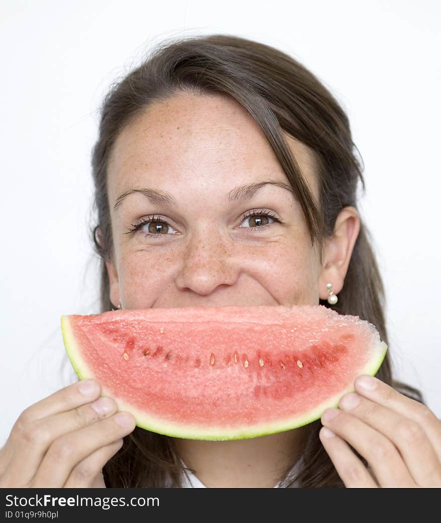 Pretty Brunette lady holds melon slice infront of face. Pretty Brunette lady holds melon slice infront of face