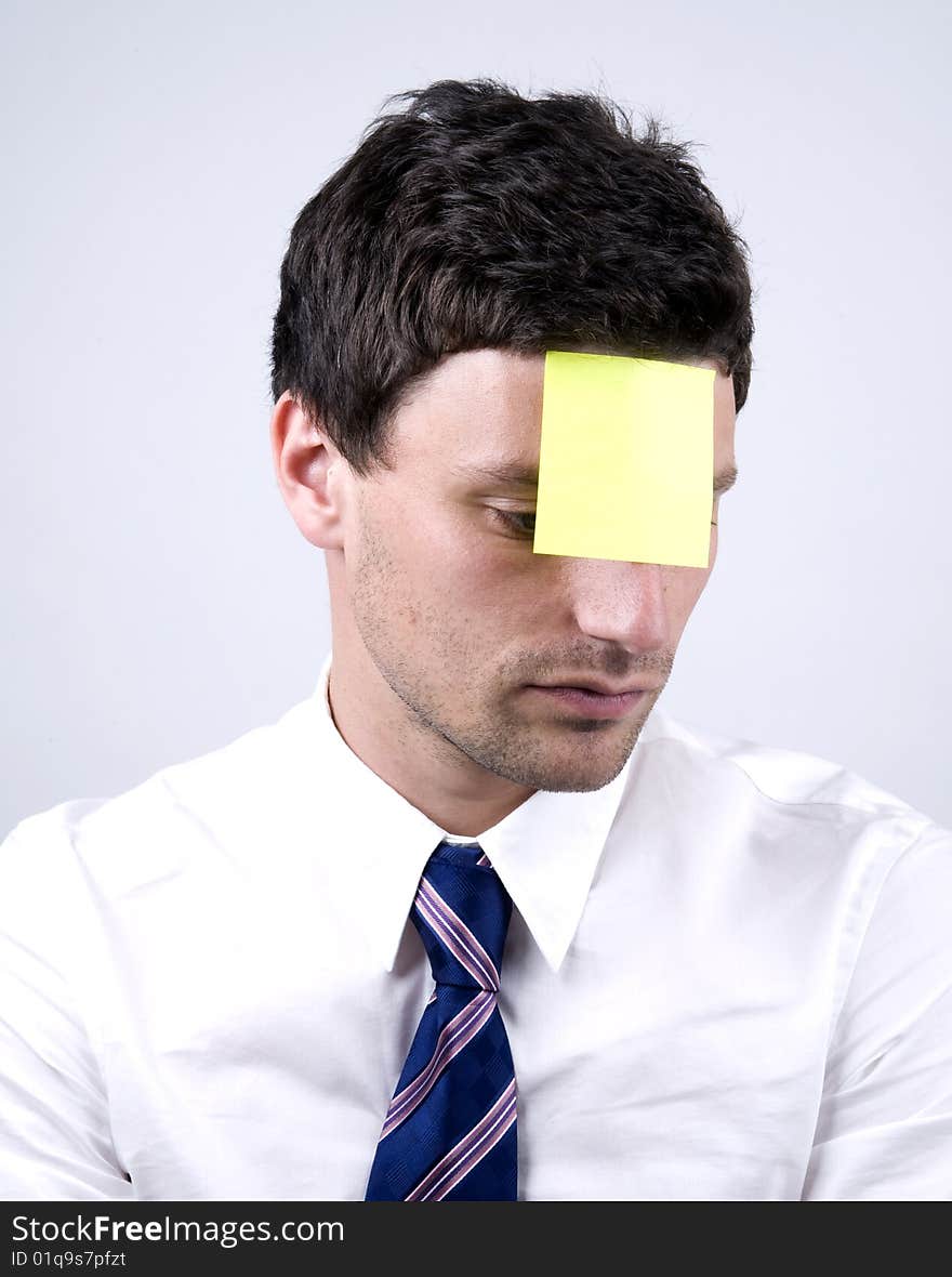 Man in shirt with nlank note on head