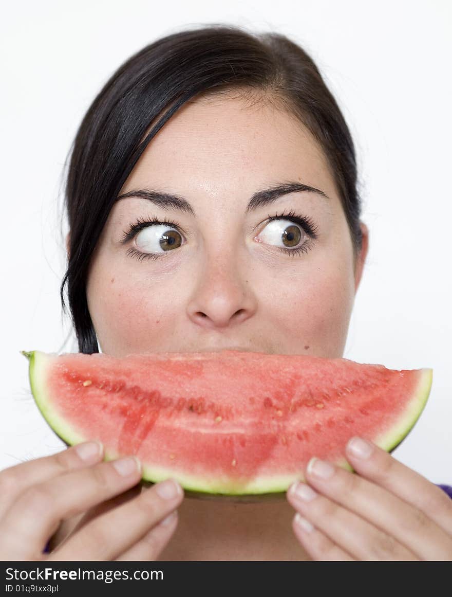 Pretty Brunette lady holds melon slice infront of face. Pretty Brunette lady holds melon slice infront of face