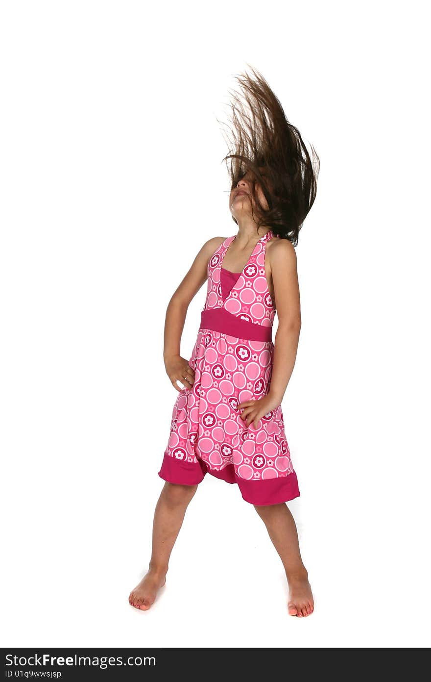 Girl in pink dress tossing her head back with hair flying. Girl in pink dress tossing her head back with hair flying