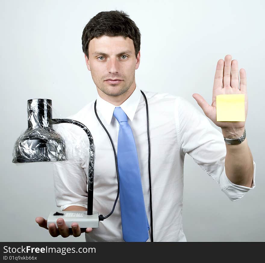 Young man holds lamp and a blank post-it