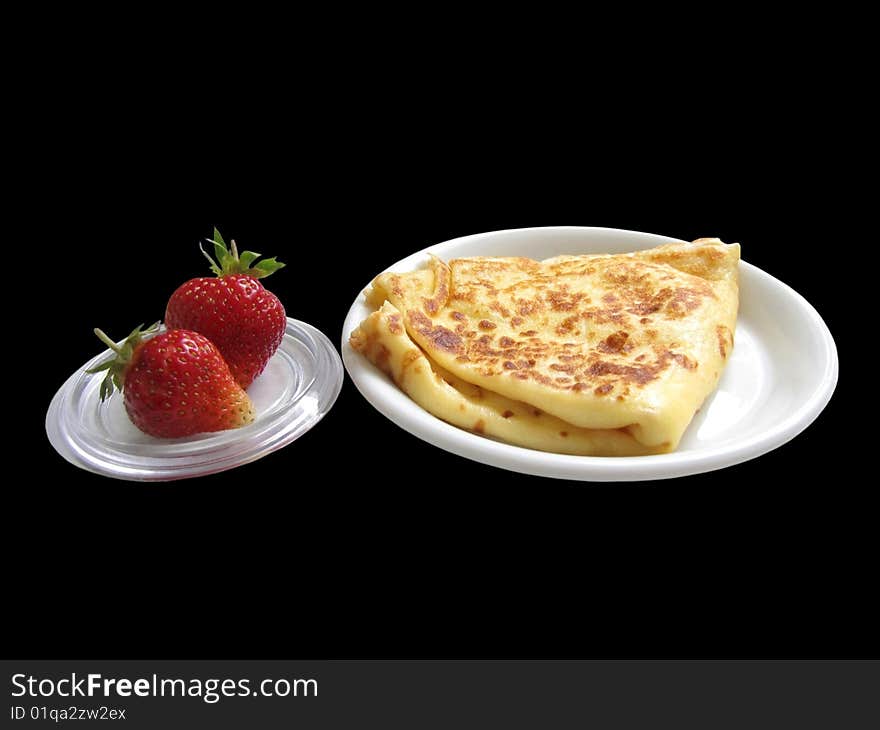 Close up pancake and strawberries on black background