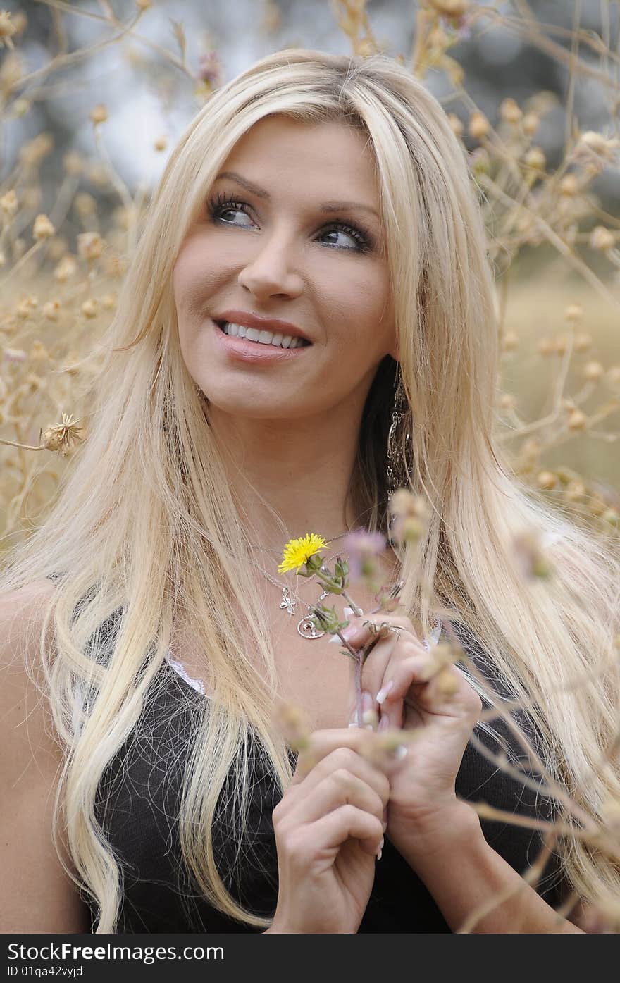 A young lady enjoying a spring afternoon in a field. A young lady enjoying a spring afternoon in a field