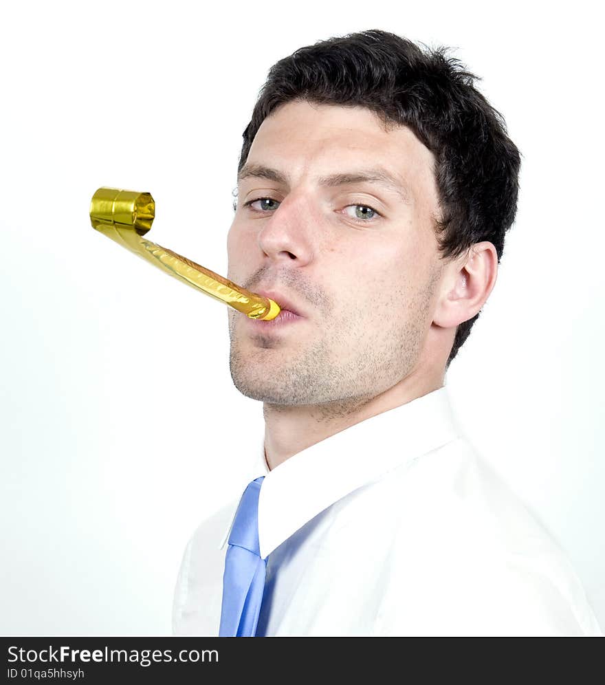 Business man blows party blower while wearing whit shirt. Business man blows party blower while wearing whit shirt.