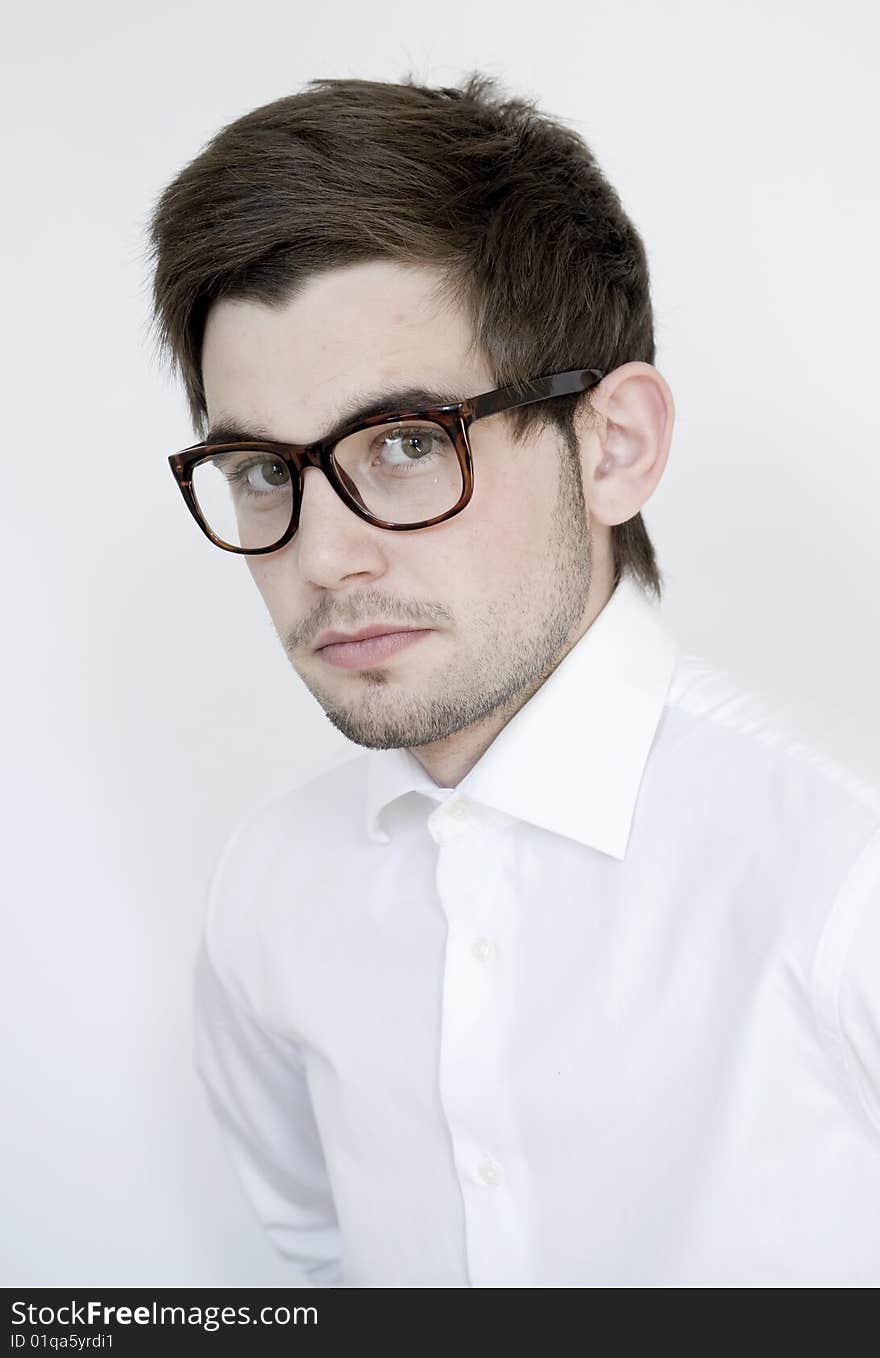 Young stylish man wears glasses and white shirt. Young stylish man wears glasses and white shirt