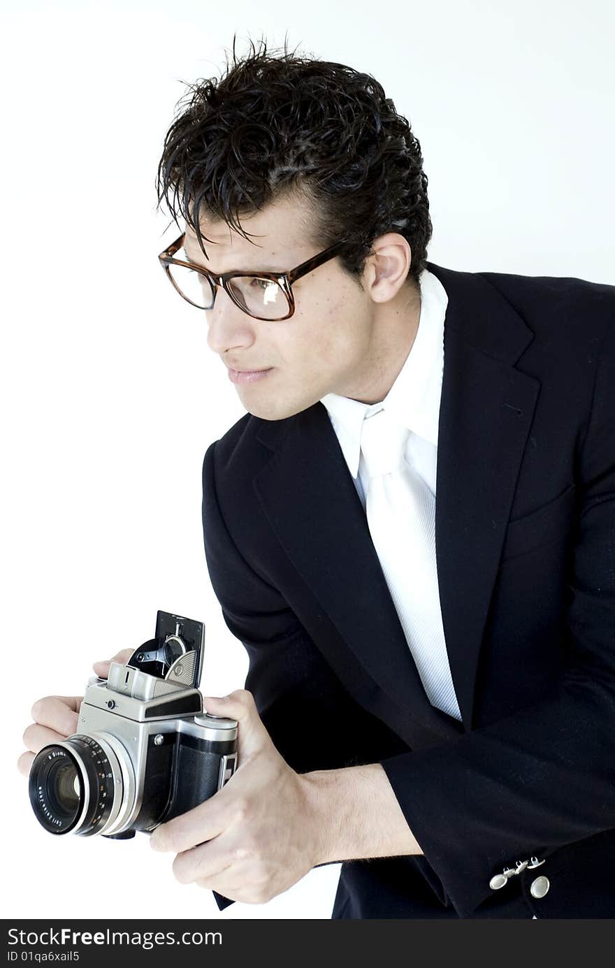 Stylish gentleman holds vintage camera while wearing suit. Stylish gentleman holds vintage camera while wearing suit