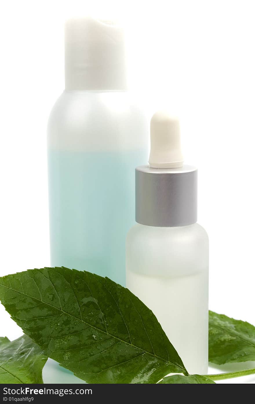 Cosmetic products with green leaf on white background