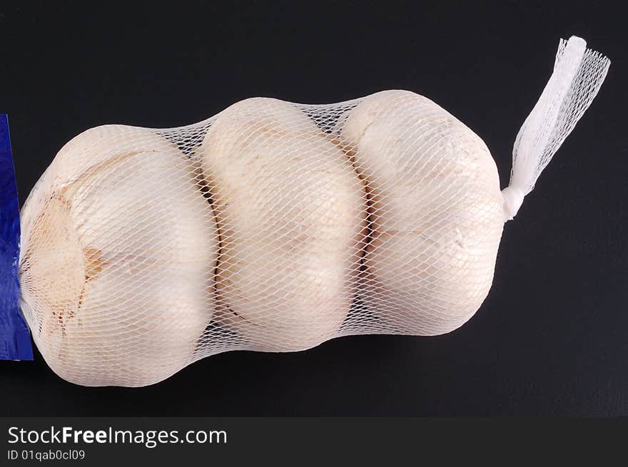 White garlic on a black background