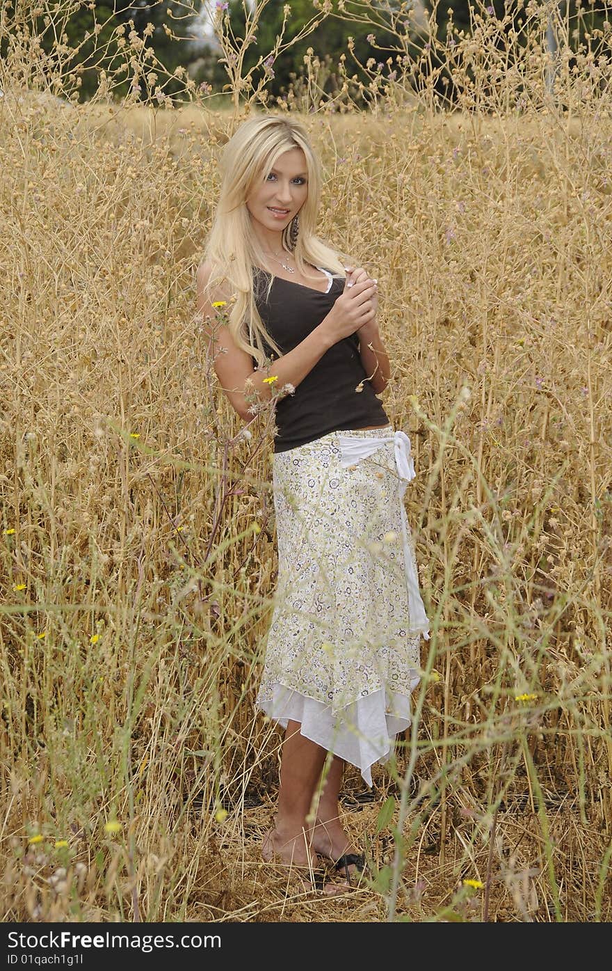 A young lady enjoying a spring afternoon in a field. A young lady enjoying a spring afternoon in a field