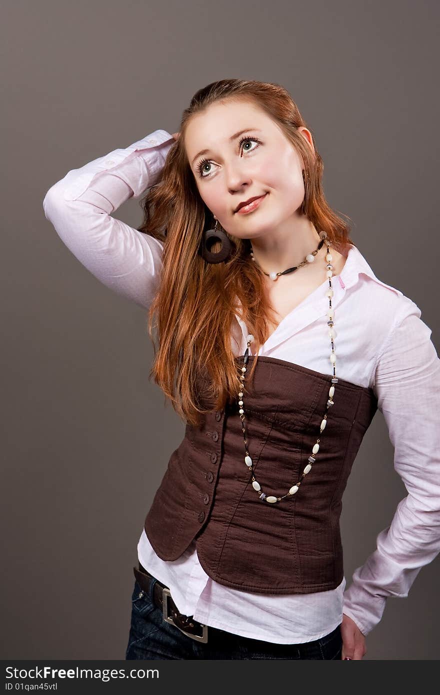 Red haired girl with hands lifted up isolated. Red haired girl with hands lifted up isolated