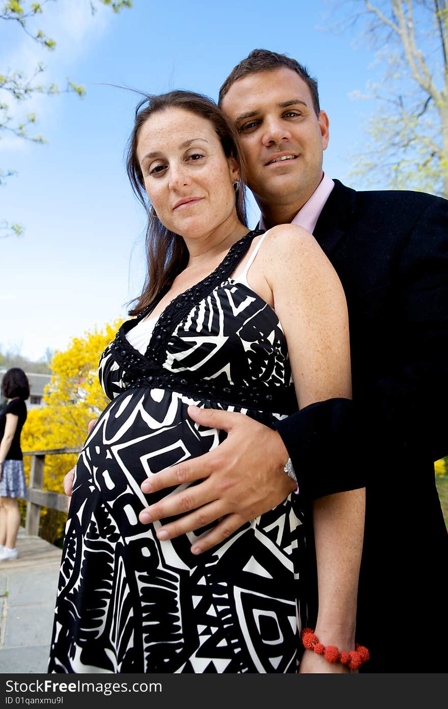 Pregnant Couple with a man's hands on her belly