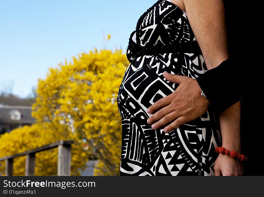 Pregnant Couple with a man's hands on her belly