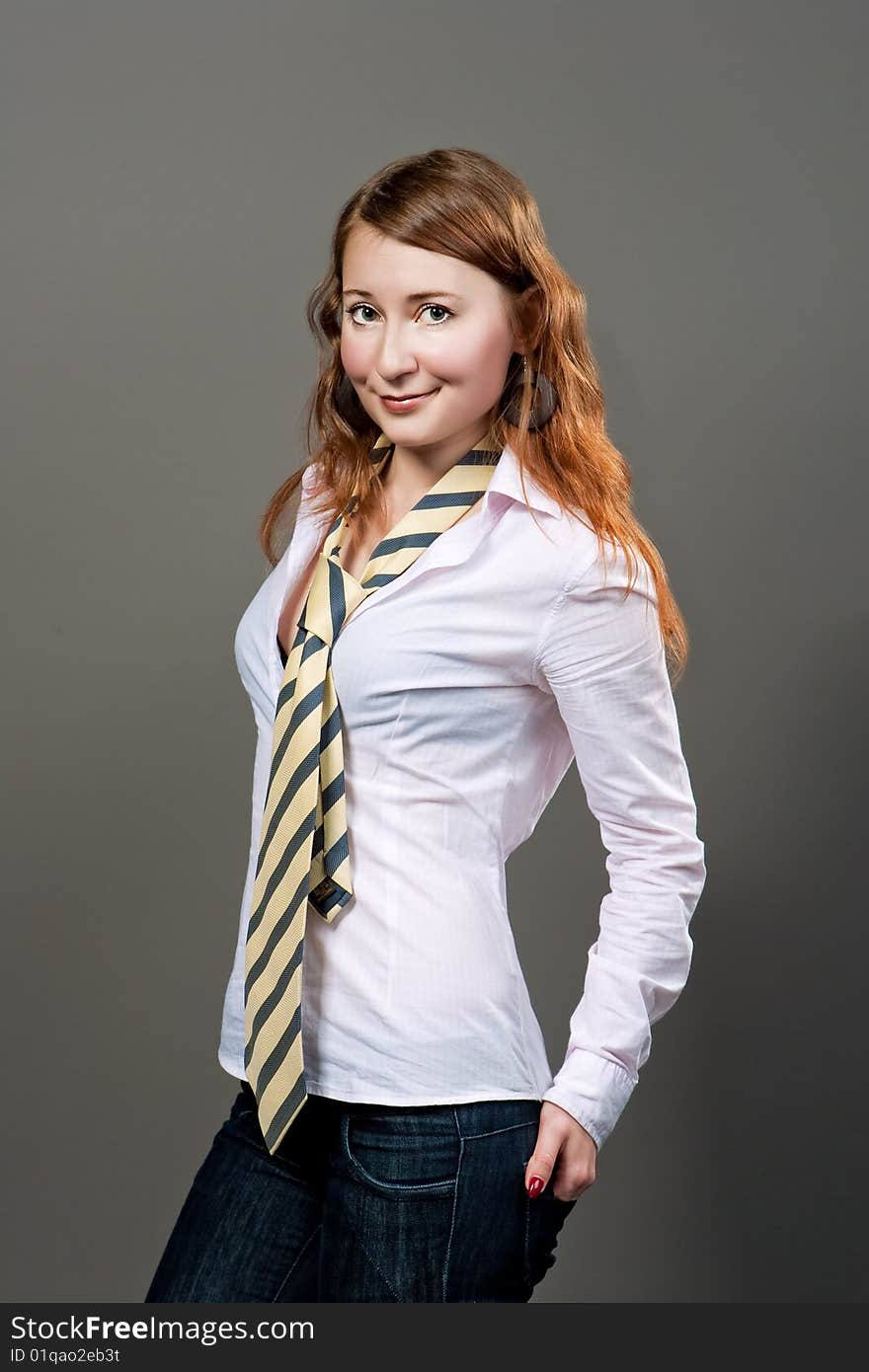 Red haired girl in striped tie isolated. Red haired girl in striped tie isolated