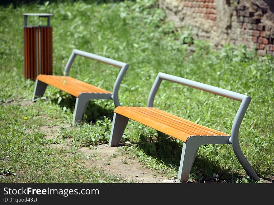 Two benches on green grass outside