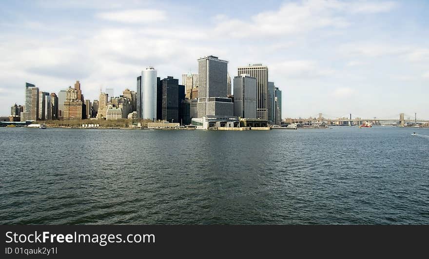 View from the harbor of lower Manhattan Island and East River with both Brooklyn and Manhattan Bridges. View from the harbor of lower Manhattan Island and East River with both Brooklyn and Manhattan Bridges