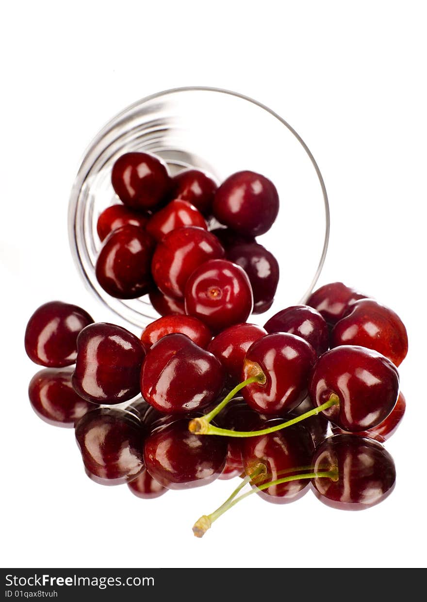 Cherry rolling out from a dish with white background