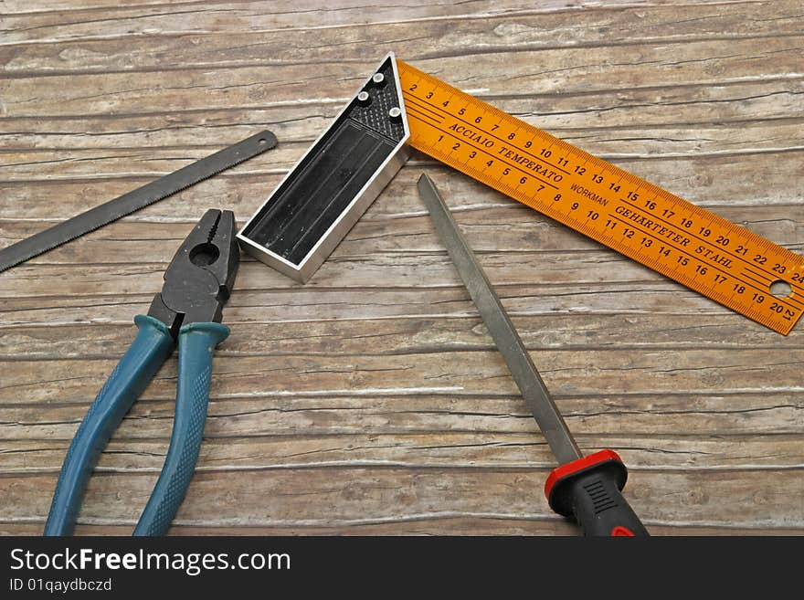 Technician's tools on old wood background