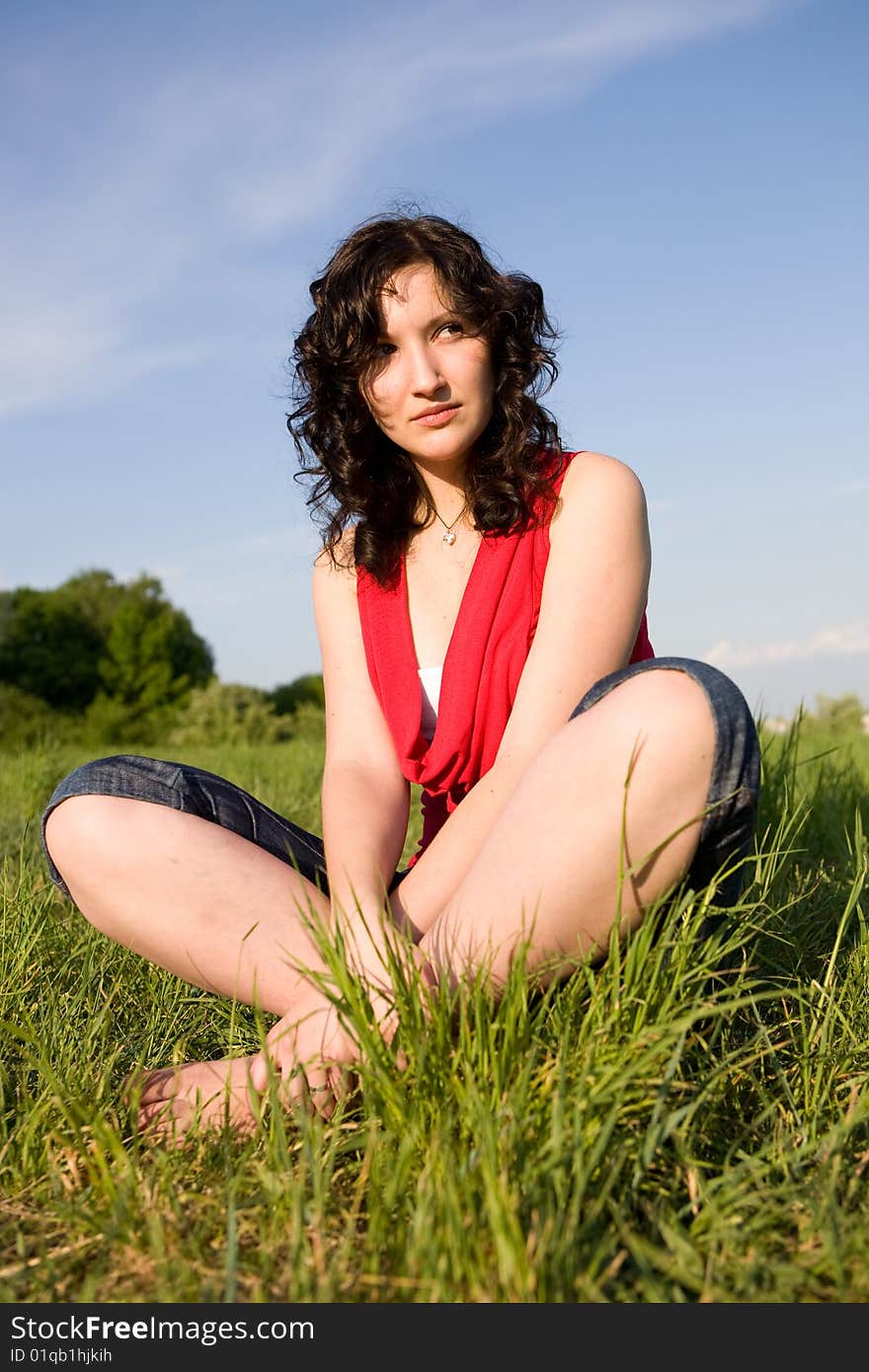 Young women resting on the meadow (summer)