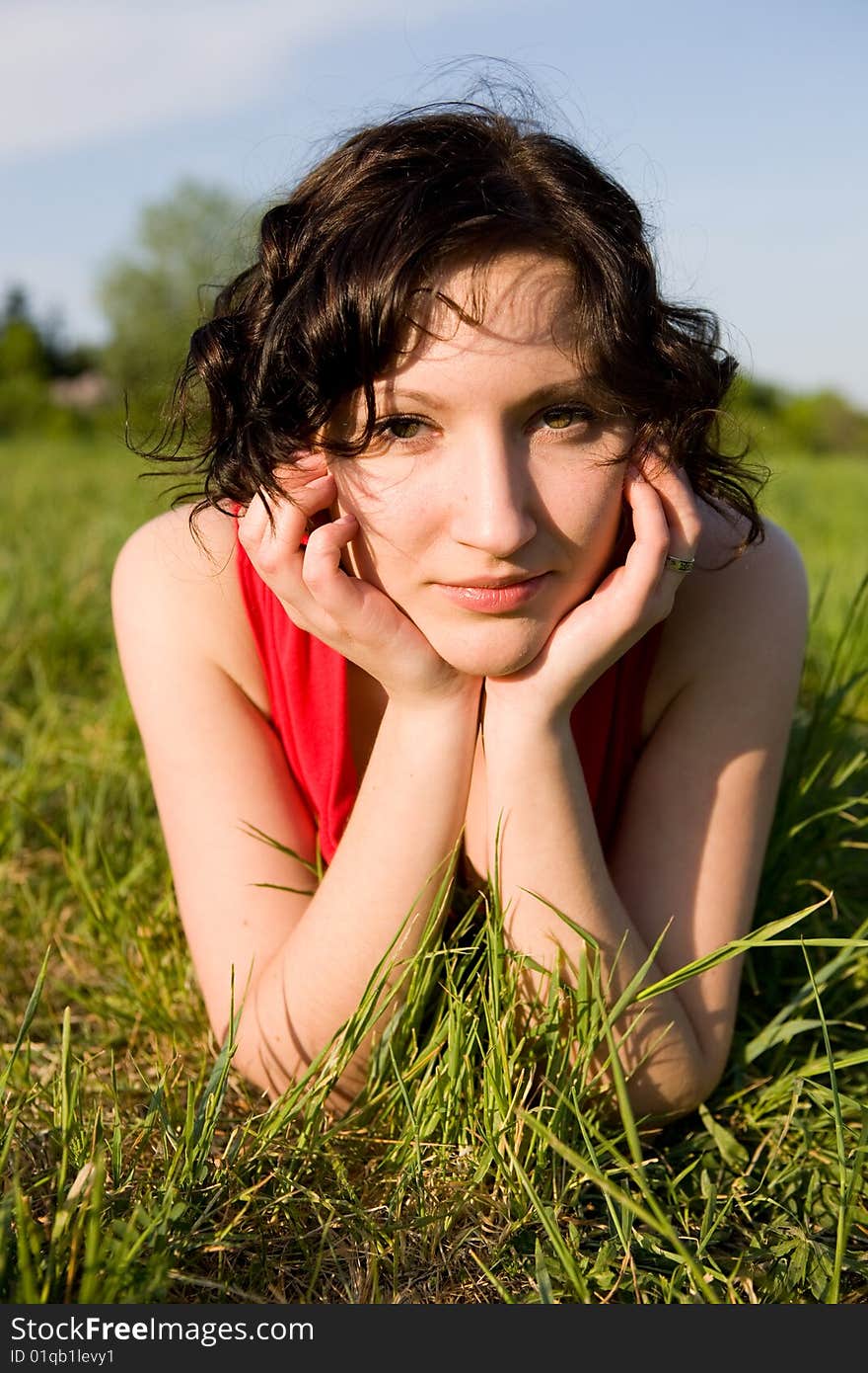 Young women resting on the meadow (summer)