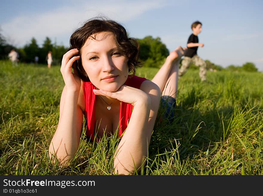 Young women resting on the meadow (summer)