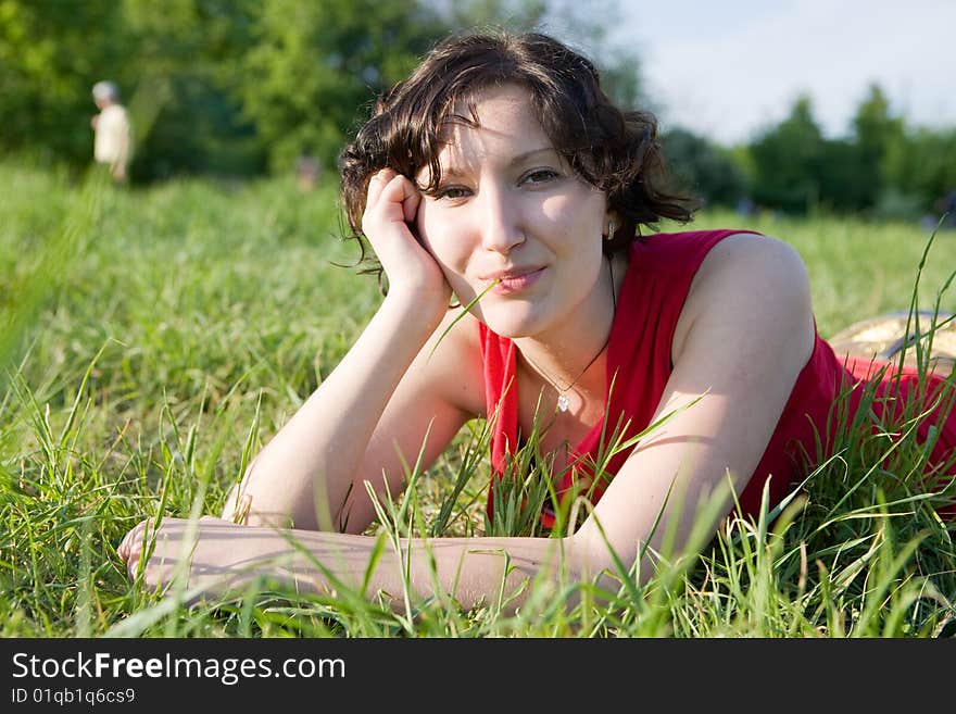 Young women resting on the meadow (summer)