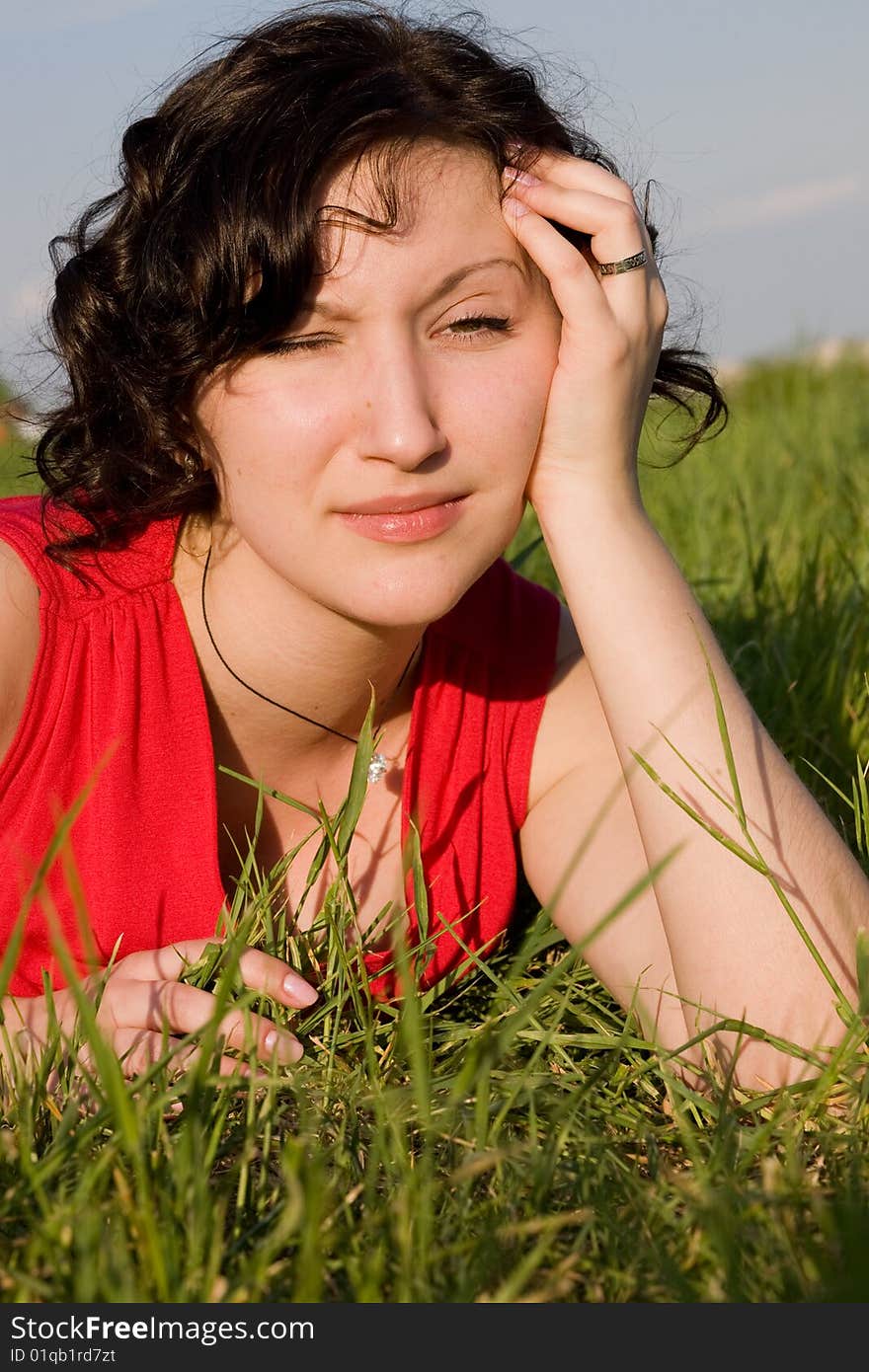 Young women resting on the meadow (summer)