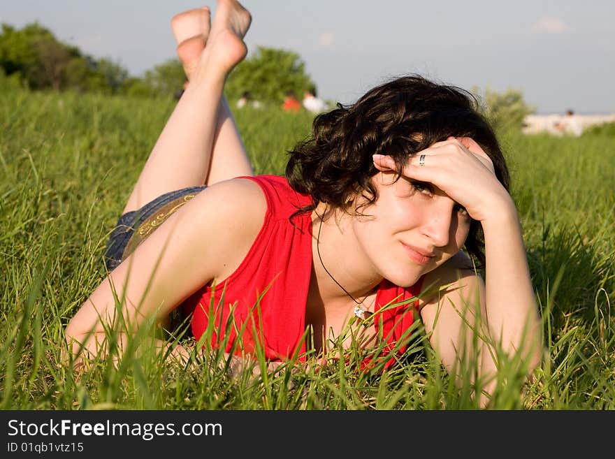 Young women resting on the meadow (summer)