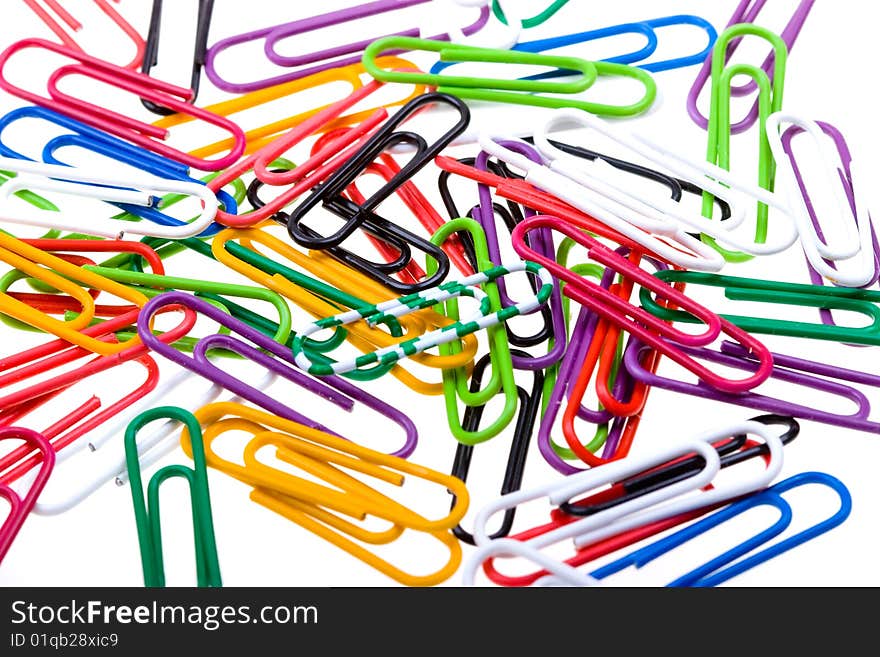 Color paper clips to background. Isolated on white