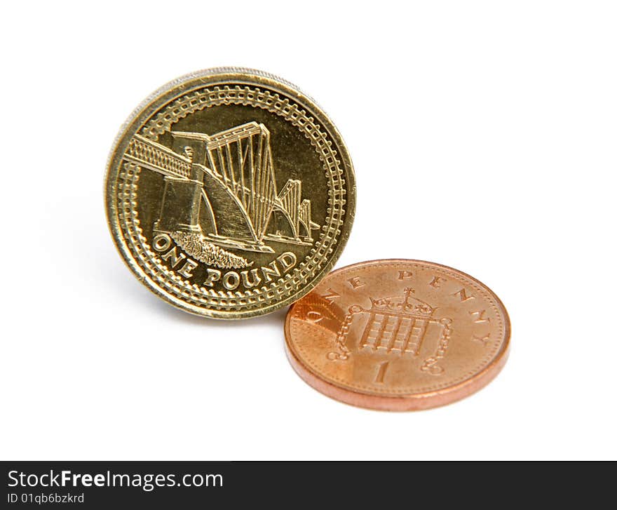 Close-up of UK pound and penny on white background