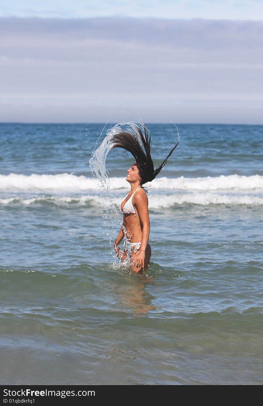 Girl with long hair in the sea