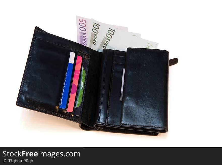 Black leather purse with money and credit cards on a white background