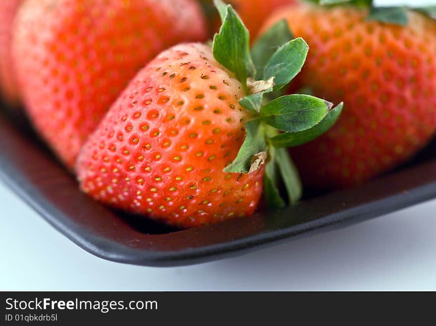 Strawberries in a black plate. Strawberries in a black plate