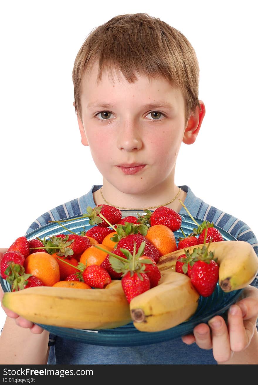 Beautiful boy showing the plate with fruits isolated on white. Beautiful boy showing the plate with fruits isolated on white.