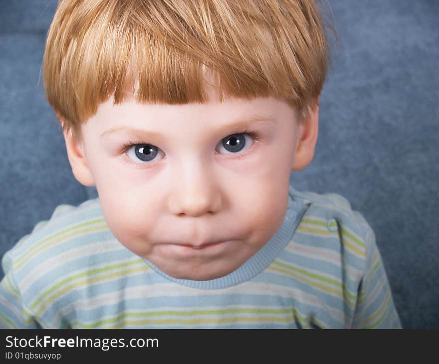 Portrait of the blond little boy on a background. Portrait of the blond little boy on a background