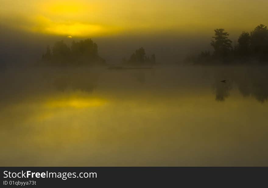 Dawn obscured by cloud and fog on Boulder Lake in Northern Minnesota