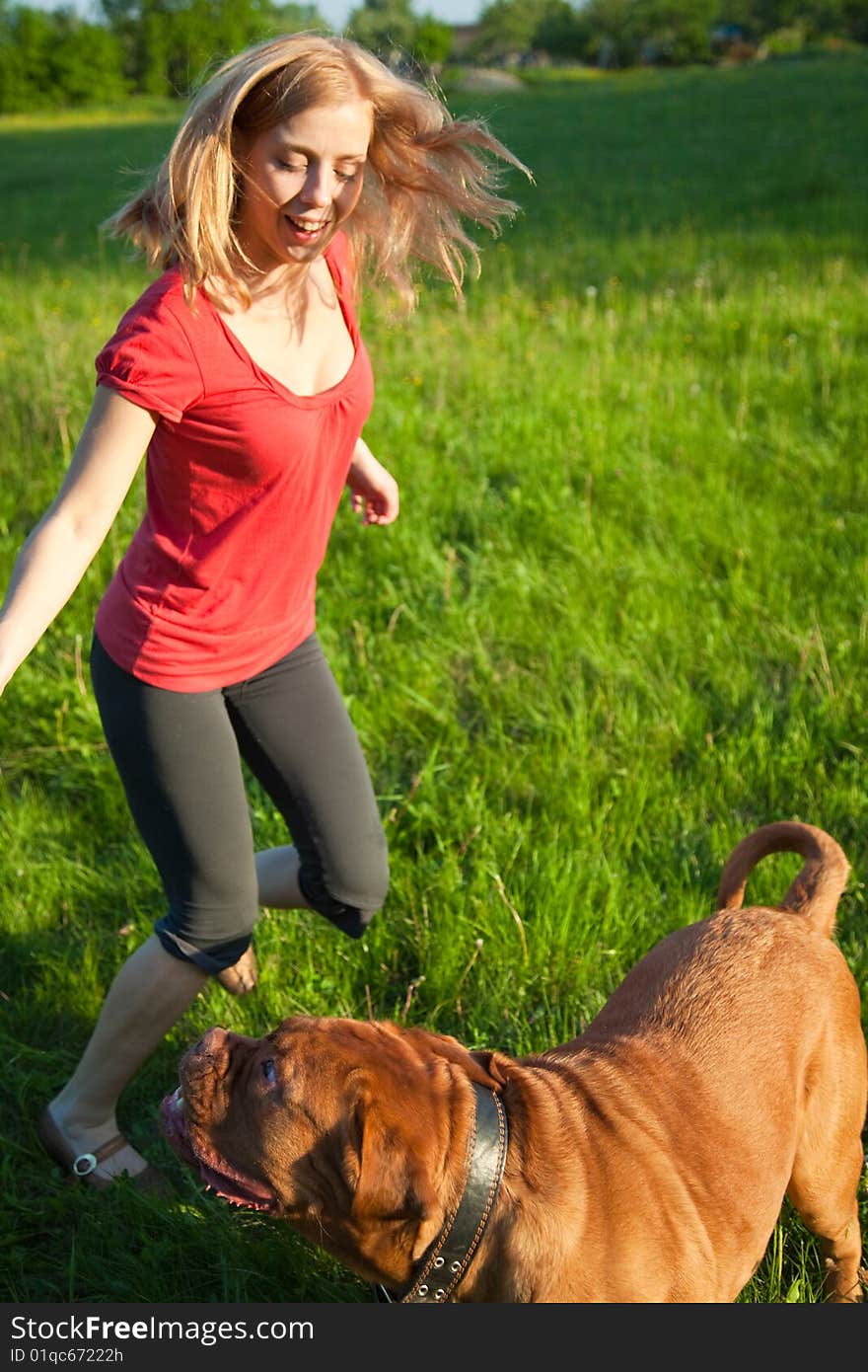 Young girl and her dog (French mastiff, Dogue de Bordeaux)