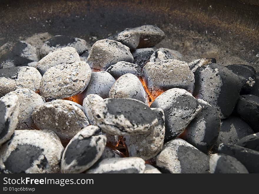 A hot barbecue grill with glowing coals.