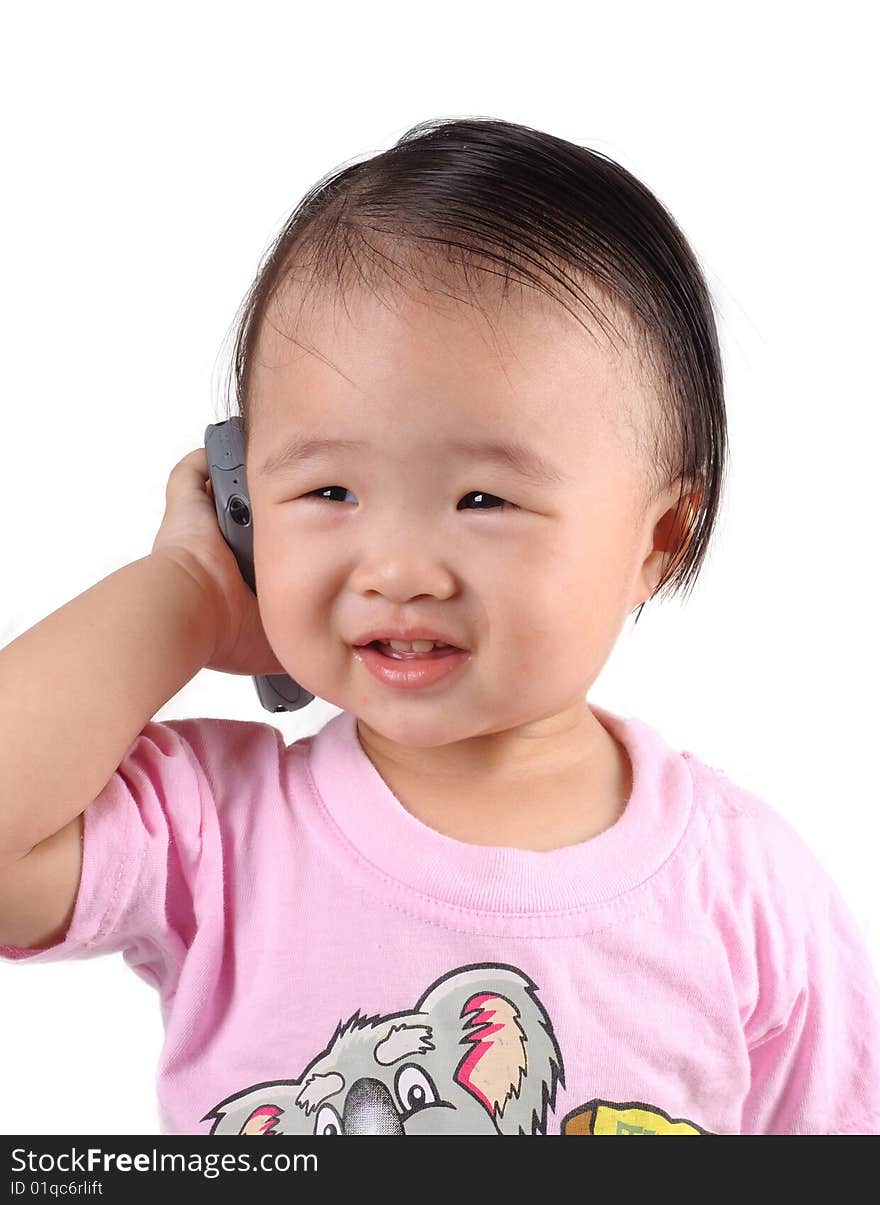 Chinese kid speak into cellphone with white background. Chinese kid speak into cellphone with white background