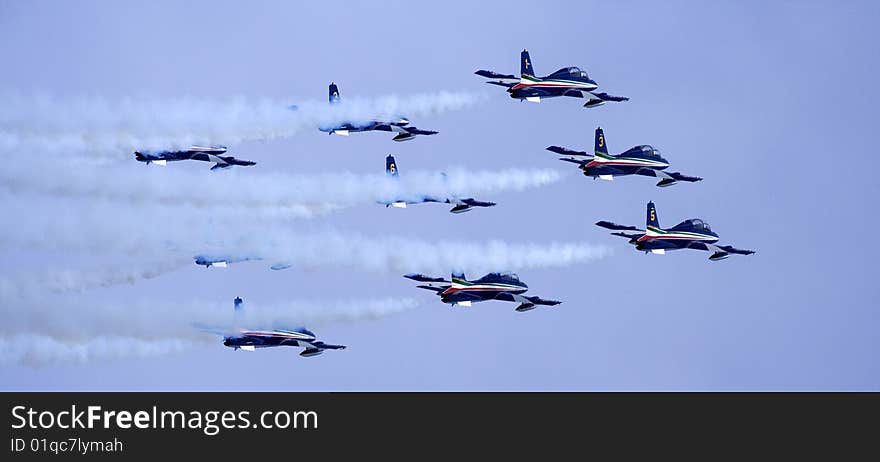 Aerobatic team of the Italian Air Force Frecce Tricolori (Three-coloured Arrows) on aircraft Aermacchi MB-339-A/PAN in flight. Aerobatic team of the Italian Air Force Frecce Tricolori (Three-coloured Arrows) on aircraft Aermacchi MB-339-A/PAN in flight.