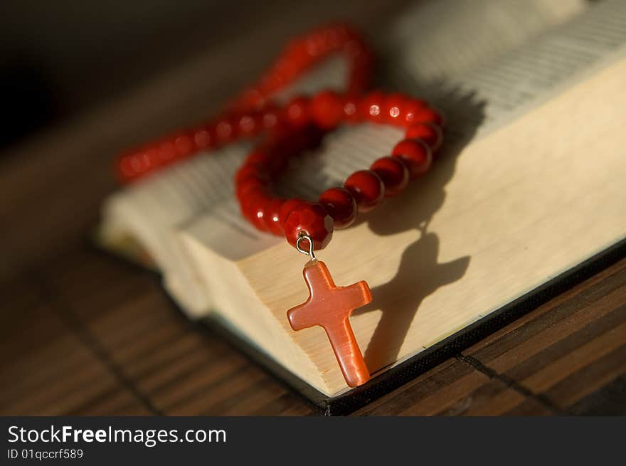 Book and red beads with cross. Book and red beads with cross