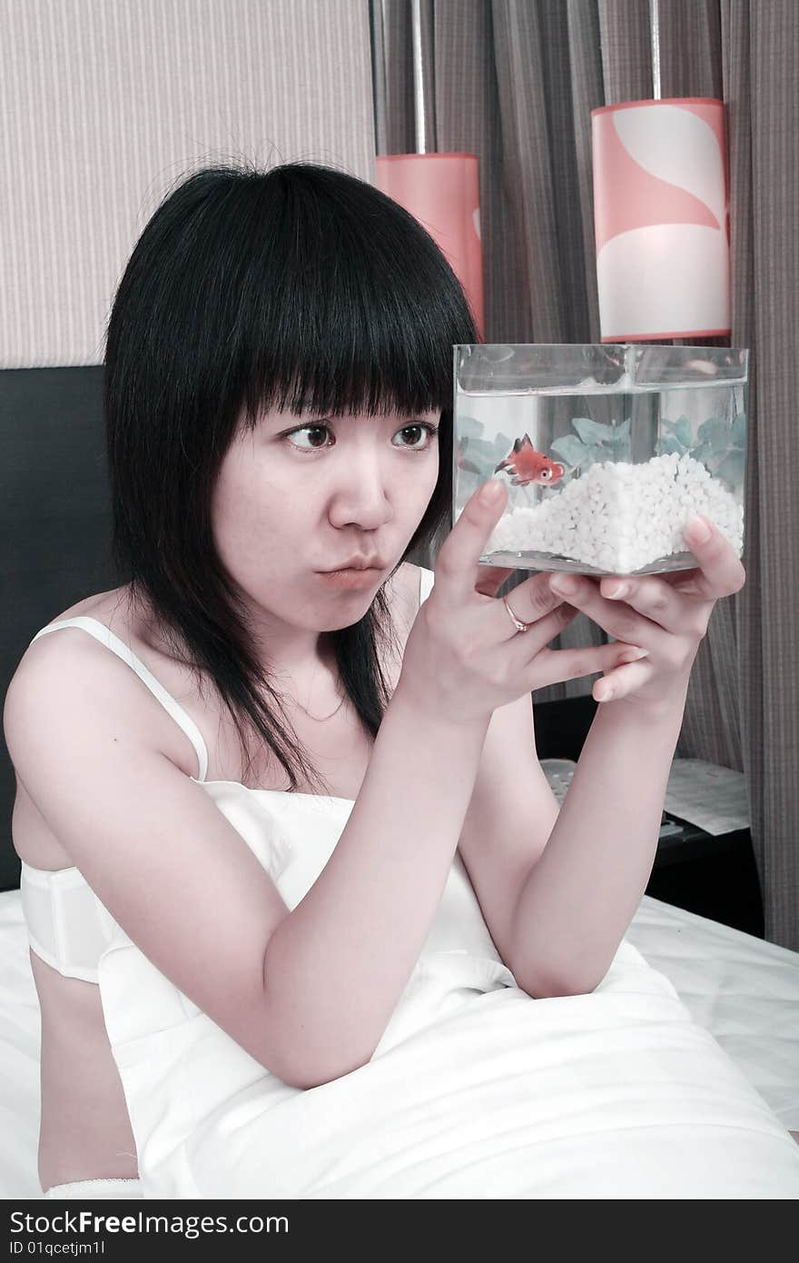 Asian girl with her goldfish