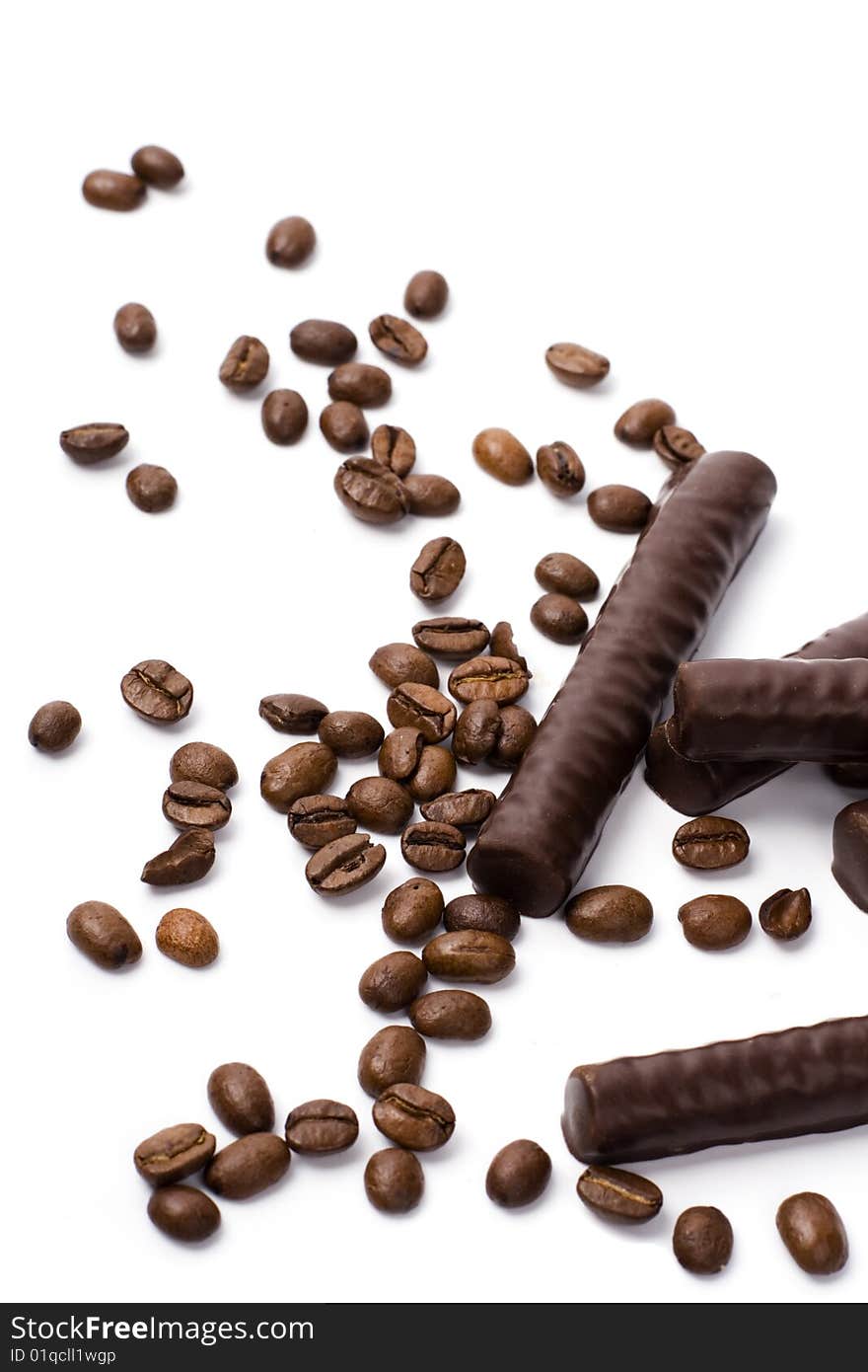 Chocolate bars and coffee beans on white background