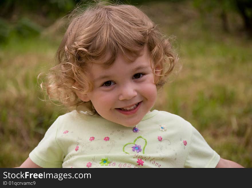 Little nice girl laughing in the garden