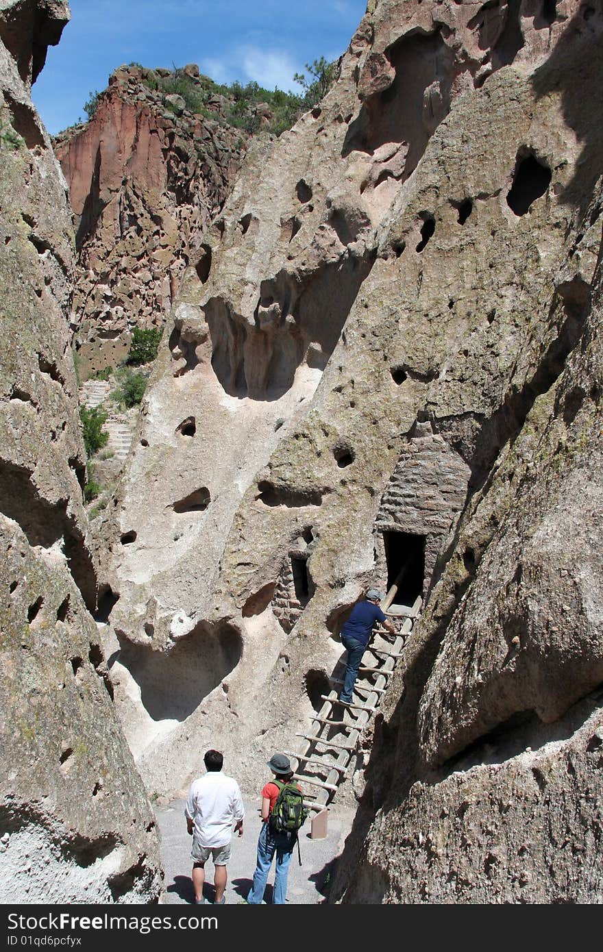 Visitors explore the mountains at Bandelier in New Mexico, the site of ancient Native American cliff dwellings.