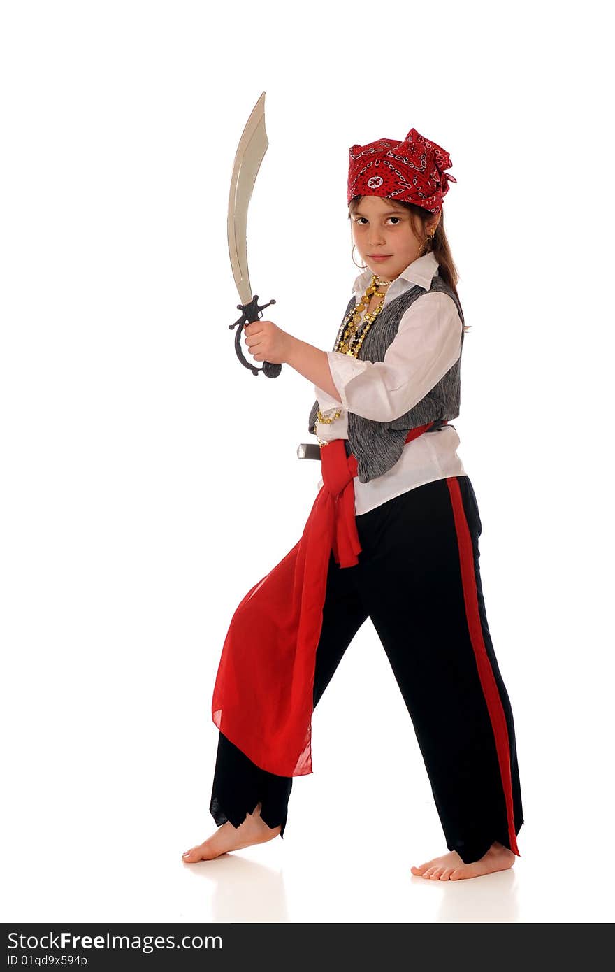 An elementary girl dresses as a pirate looking at the viewer with her sword drawn. Isolated on white. An elementary girl dresses as a pirate looking at the viewer with her sword drawn. Isolated on white.