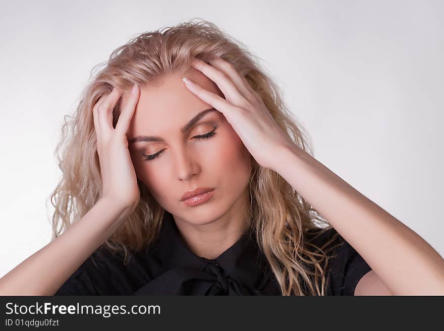 A shot of a girl with a headache, studio shot