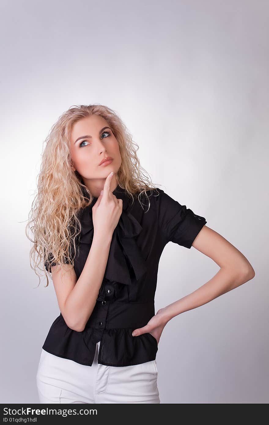 Photo of a businesswoman looking up and thinking, studio shot