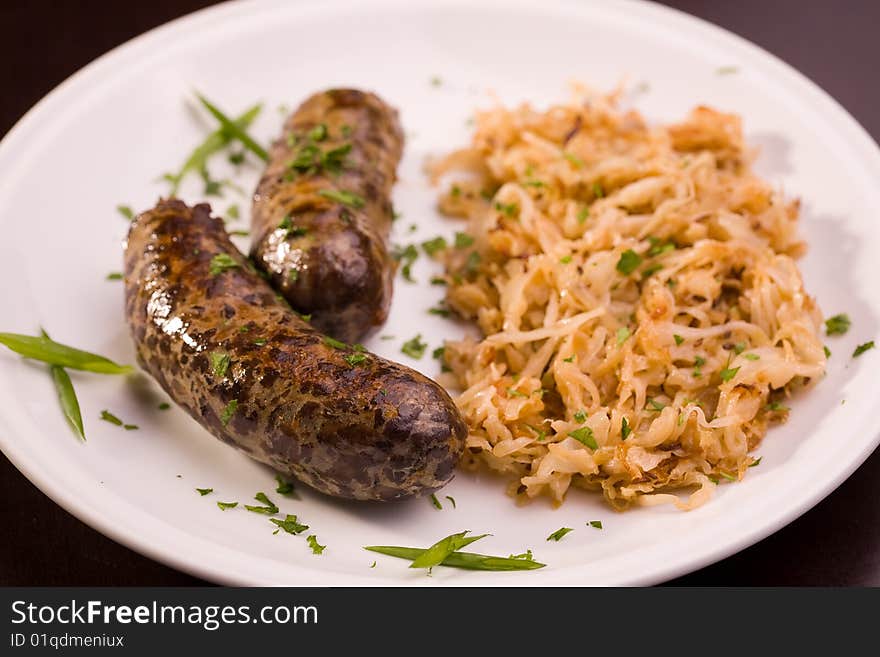 Two grilled bavarian sausage with cabbage