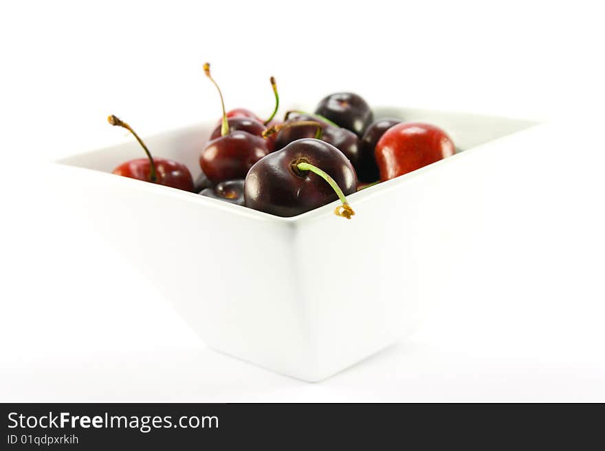 Bowl of cherries on a white background with clipping path